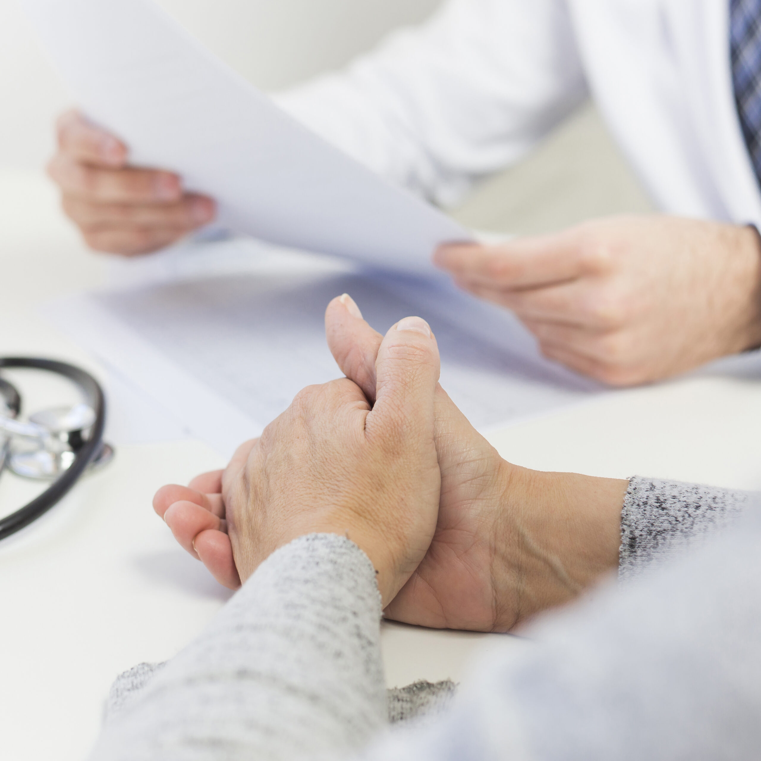 Patient with doctor reviewing a medical report